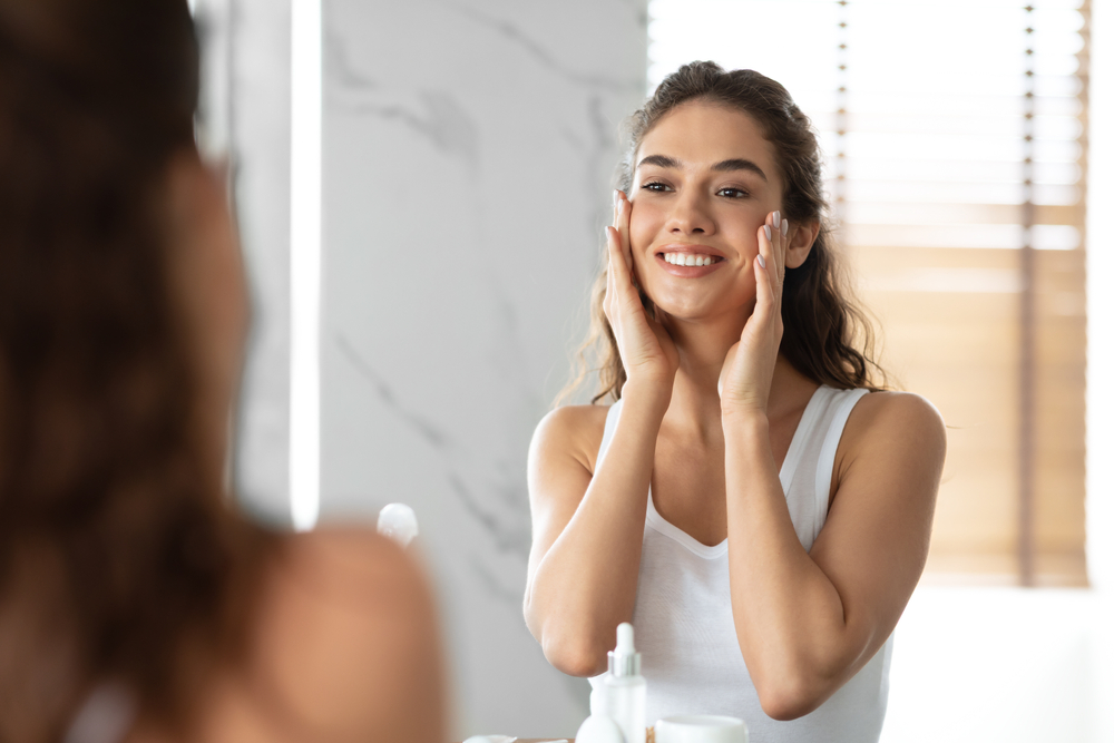 Woman looking in the mirror at her deep plane facelift results in Pittsburgh