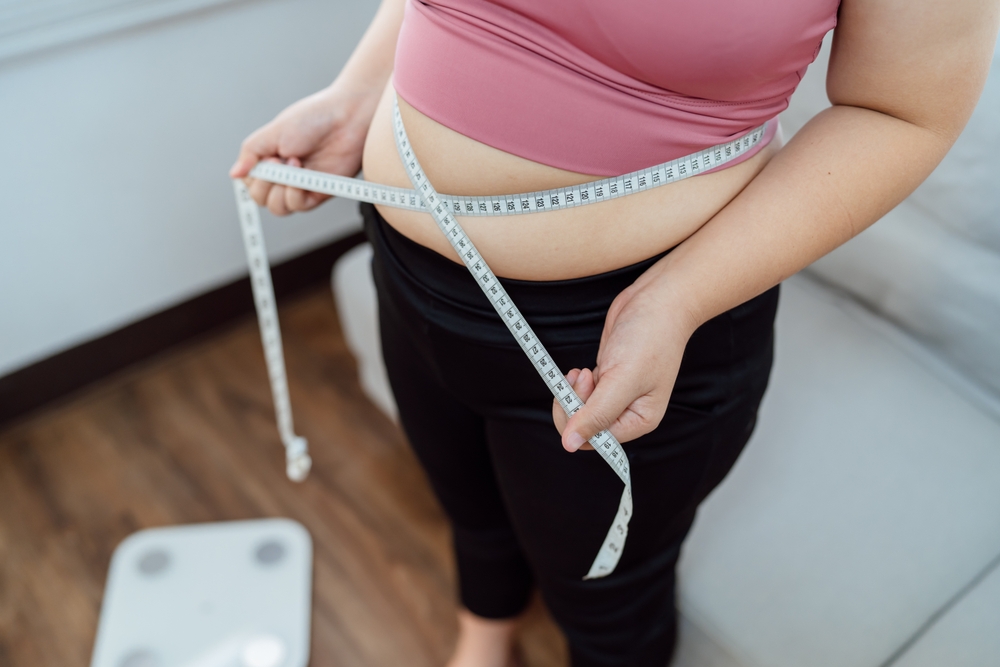 Woman measuring herself after taking GLP-1 in Pittsburgh, PA